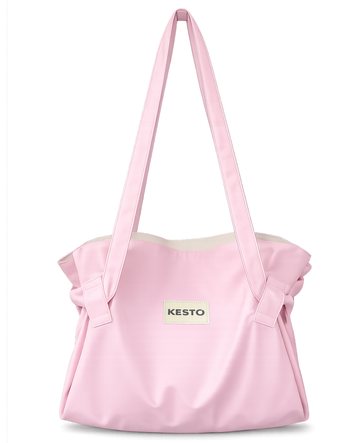 A light pink fabric tote bag with long shoulder straps, gathered ruffle details on the sides, and a small white rectangular patch on the front featuring the brand name 'KESTO'.