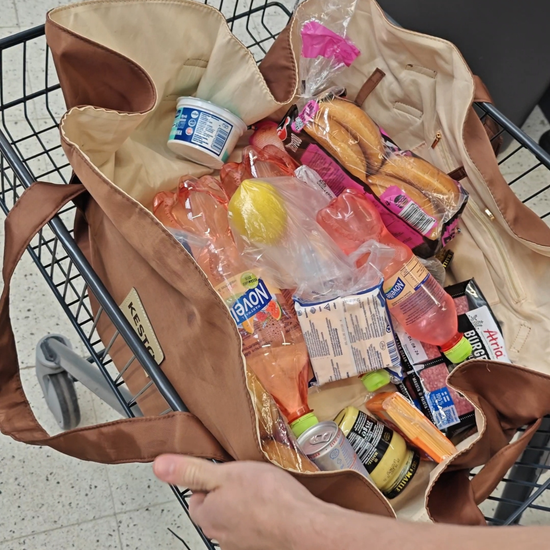 Packing groceries on the brown KESTO Bag that opens completely flat for easy packing