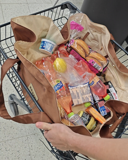 Packing groceries on the brown KESTO Bag that opens completely flat for easy packing