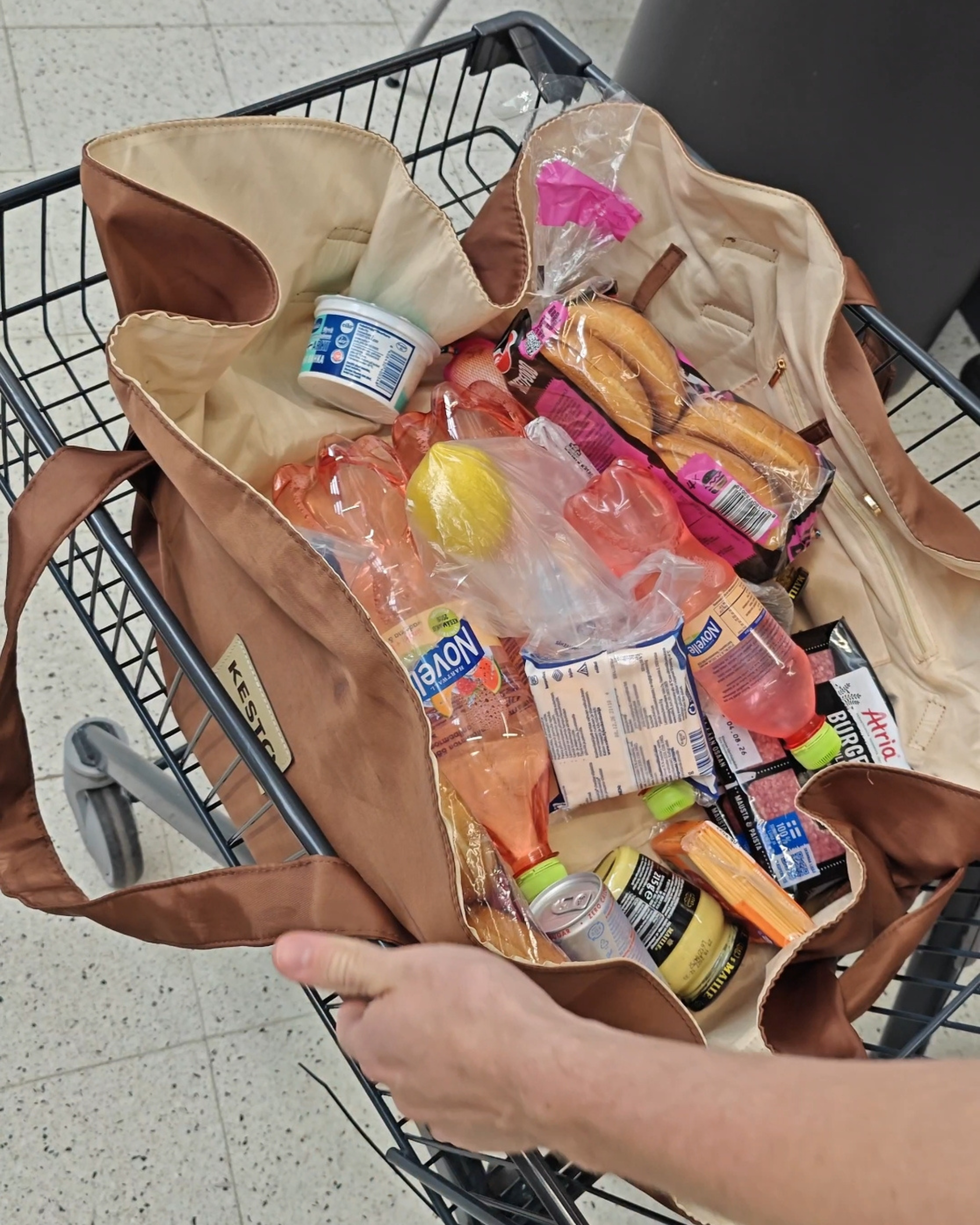 Packing groceries on the brown KESTO Bag that opens completely flat for easy packing